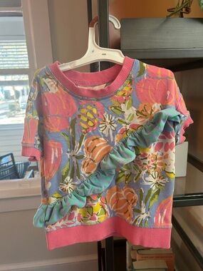 Matilda Jane Pink Floral Ruffle Sweatshirt Top with Blue Background